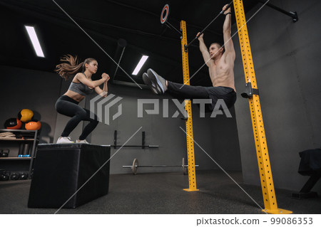 Couple have crossfit training at gym together Couple have crossfit training at gym together 99086353