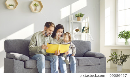 Happy mom and dad reading book to their little daughter Happy mom and dad reading book to their little daughter 99086437