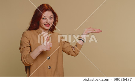 Woman pointing empty place, advertising area for commercial text, copy space for goods promotion Woman pointing empty place, advertising area for commercial text, copy space for goods promotion 99086487