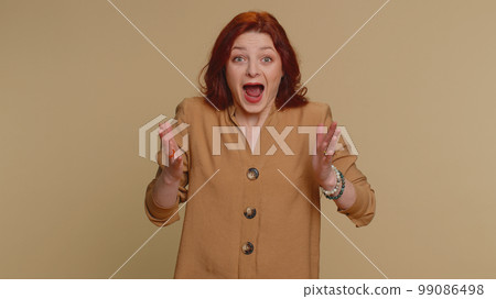 Excited amazed woman surprise looking at camera with big eyes, shocked by sudden victory wow emotion 99086498