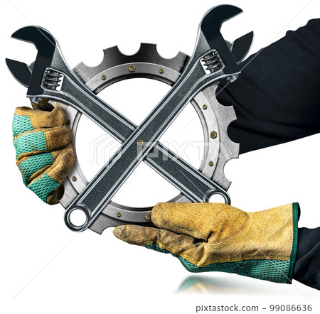 Gloved Hands Holding a Metal Cog with Two Steel Adjustable Wrenches 99086636