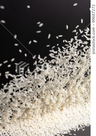 Japanese Rice flying explosion, white grain rices explode abstract cloud fly. Beautiful complete seed rice splash in air, food object design. Black background high speed shutter freeze stop motion 99087272