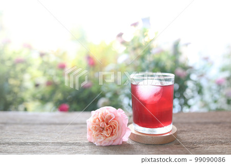 Rosella Juice in a glass cup on wooden tray Rosella Juice in a glass cup on wooden tray 99090086