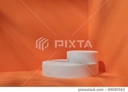 Minimal stage for a modern product display on a white podium cilinre on an orange background. Minimal stage for a modern product display on a white podium cilinre on an orange background. 99090562