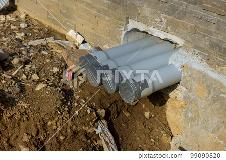 Installation new plastic sewer pipes on ground at trench during assembly Installation new plastic sewer pipes on ground at trench during assembly 99090820