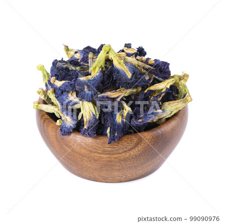 Butterfly pea flowers in wooden bowl, isolated on white background. Blue herbal tea. Clitoria Ternatea. Butterfly pea flowers in wooden bowl, isolated on white background. Blue herbal tea. Clitoria Ternatea. 99090976