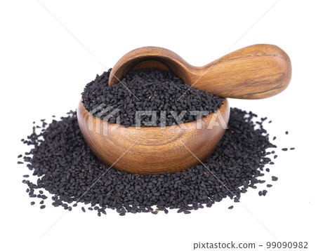 Black cumin seeds in wooden bowl and spoon, isolated on white background. Heap of black nigella seeds. Nigella sativa. Black cumin seeds in wooden bowl and spoon, isolated on white background. Heap of black nigella seeds. Nigella sativa. 99090982