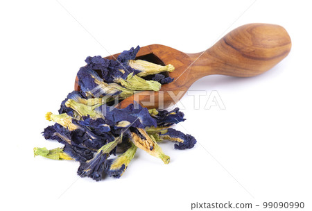 Butterfly pea flowers in wooden spoon, isolated on white background. Blue herbal tea. Clitoria Ternatea. Butterfly pea flowers in wooden spoon, isolated on white background. Blue herbal tea. Clitoria Ternatea. 99090990