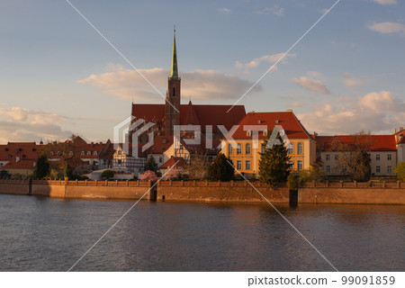 Poland, Wroclaw, April 16, 2022. View to Odra River and Tumski Island. Old Town of Wroclaw in Spring Poland, Wroclaw, April 16, 2022. View to Odra River and Tumski Island. Old Town of Wroclaw in Spring 99091859