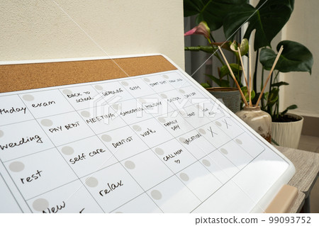 Monthly PLANNER filled with appointments and plans for next month. Busy month schedule Magnetic board with the days of the month. Place to enter important matters schedule. Concept for business 99093752