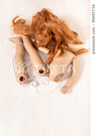 disassembled plastic doll with red hair on board disassembled plastic doll with red hair on board 99095738