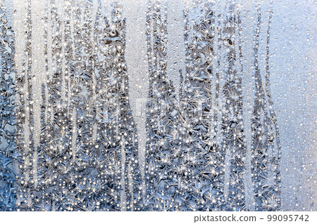 sunshine on frost on surface on home window glass 99095742