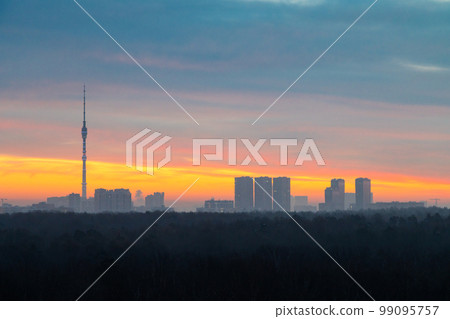 early winter dawn over dark forest and city early winter dawn over dark forest and city 99095757
