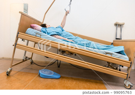 sloped hospital bed with patient holding handle 99095763