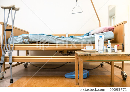electric hospital bed, crutches and table at home 99095771