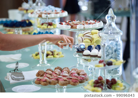 Women's hands taking sweets Women's hands taking sweets 99096843