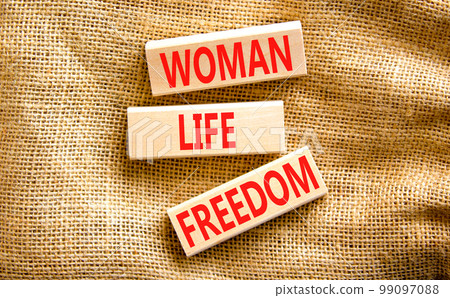 Woman life freedom symbol. Concept words Woman Life Freedom on wooden blocks on a beautiful canvas table canvas background. Social issue woman life freedom concept. Copy space. Woman life freedom symbol. Concept words Woman Life Freedom on wooden blocks on a beautiful canvas table canvas background. Social issue woman life freedom concept. Copy space. 99097088