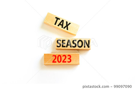 Tax season 2023 symbol. Concept words Tax season 2023 on wooden blocks on a beautiful white table white background. Business Tax season 2023 concept. Copy space. 99097090
