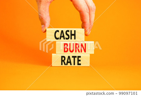 Cash burn rate symbol. Concept words Cash burn rate on wooden blocks on a beautiful orange table orange background. Businessman hand. Business cash burn rate concept. Copy space. Cash burn rate symbol. Concept words Cash burn rate on wooden blocks on a beautiful orange table orange background. Businessman hand. Business cash burn rate concept. Copy space. 99097101