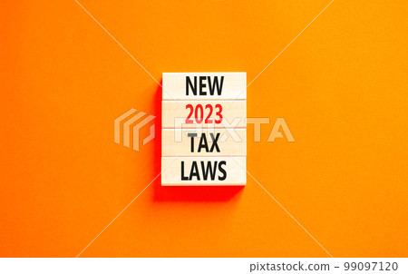 New 2023 tax laws symbol. Concept words New 2023 tax laws on wooden blocks. Beautiful orange table orange background. Business new 2023 tax laws concept. Copy space. New 2023 tax laws symbol. Concept words New 2023 tax laws on wooden blocks. Beautiful orange table orange background. Business new 2023 tax laws concept. Copy space. 99097120