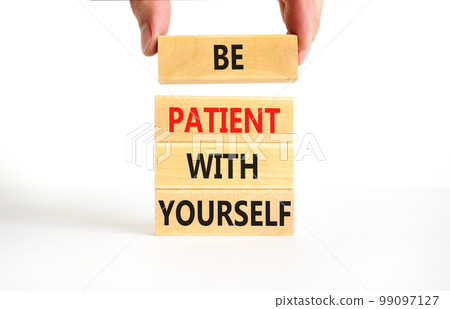 Patient with yourself symbol. Concept words Be patient with yourself on wooden blocks. Beautiful white table white background. Businessman hand. Business patient with yourself concept. Copy space. 99097127