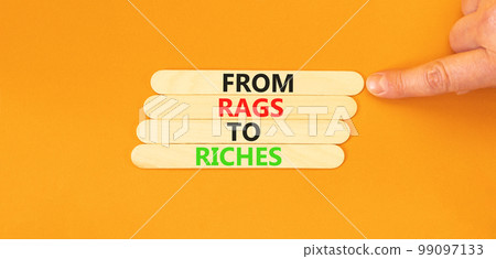 Rags or riches symbol. Concept words From rags to riches on wooden stick. Beautiful orange table orange background. Businessman hand. Business rags or riches concept. Copy space. Rags or riches symbol. Concept words From rags to riches on wooden stick. Beautiful orange table orange background. Businessman hand. Business rags or riches concept. Copy space. 99097133