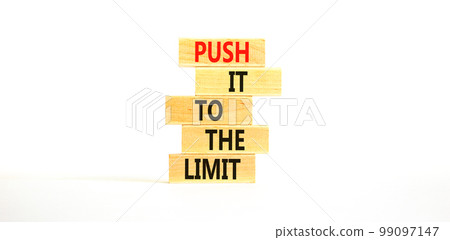 Push it to the limit symbol. Concept words Push it to the limit on wooden blocks. Beautiful white table white background. Business push it to the limit concept. Copy space. 99097147