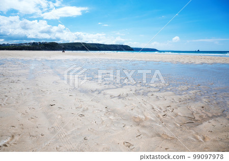 Beautiful Newquay beach with blue sea, stone cliffs and white sand in Cornwall, south west England, selective focus 99097978