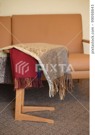 Scarves and stoles on the table, fashion items Scarves and stoles on the table, fashion items 99098643