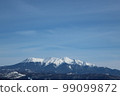 A distant view of the winter mountains covered with snow under the blue sky 99099872