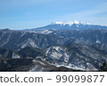 A distant view of the winter mountains covered with snow under the blue sky 99099877