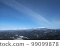 A distant view of the winter mountains covered with snow under the blue sky 99099878
