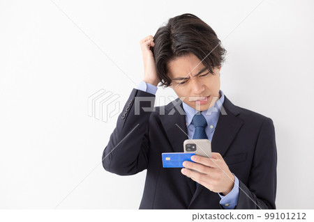 A young man who pays by card, smart phone, worries A young man who pays by card, smart phone, worries 99101212