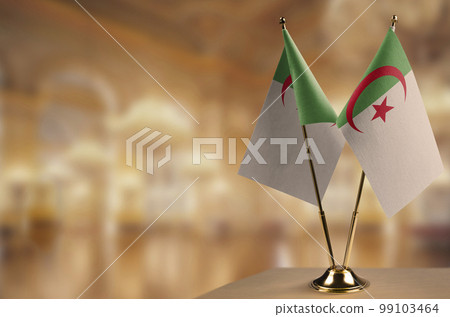 Small flags of the Algeria on an abstract blurry background Small flags of the Algeria on an abstract blurry background 99103464
