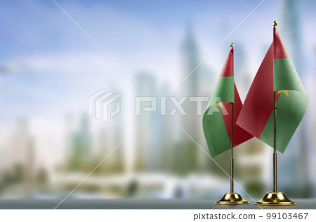 Small flags of the Burkina Faso on an abstract blurry background 99103467