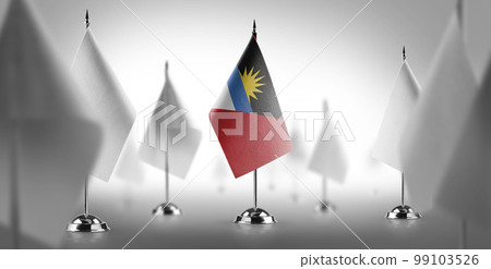 The national flag of the Antigua and Barbuda surrounded by white flags 99103526