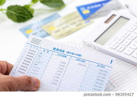 Men's hand looking at the details of the passbook 99105427