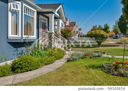 Front yard of family houses along the street on sunny day Front yard of family houses along the street on sunny day 99105614