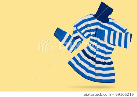 Women's sweater with a collar, in blue and white stripes, as if showing hands to the side, on a yellow background Women's sweater with a collar, in blue and white stripes, as if showing hands to the side, on a yellow background 99106219