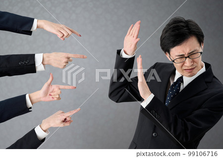 Asian businessman blamed at work 99106716