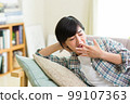A young woman yawning on the sofa, yawning, relaxing, taking a nap, resting, taking a nap 99107363