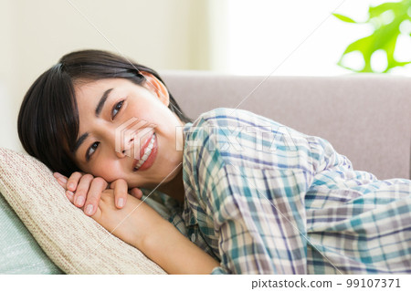 A young woman relaxing on the sofa Relax Nap Break Nap 99107371