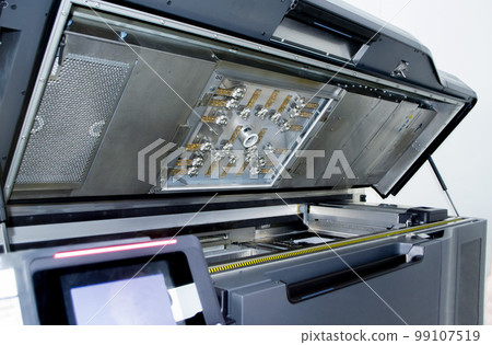 Top of large industrial printer with lid open. Multi Jet Fusion. Large industrial 3D printer printing polyimide powder. Industrial equipment. New modern 3D printing additive progressive technology MJF Top of large industrial printer with lid open. Multi Jet Fusion. Large industrial 3D printer printing polyimide powder. Industrial equipment. New modern 3D printing additive progressive technology MJF 99107519
