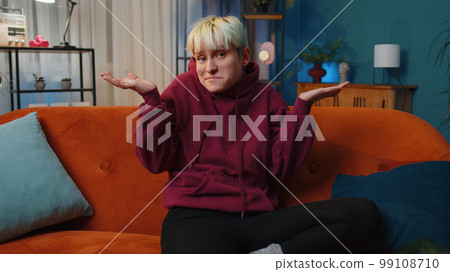 Confused woman feeling embarrassed about ambiguous question, having doubts, no idea 99108710