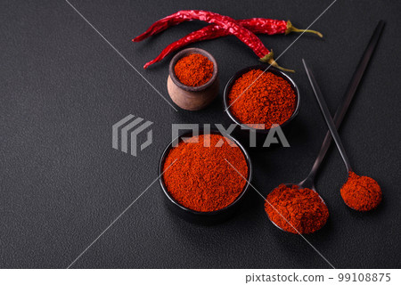 Spice smoked paprika in the form of powder in bowls and spoons Spice smoked paprika in the form of powder in bowls and spoons 99108875