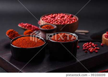 Spice smoked paprika in the form of powder in bowls and spoons Spice smoked paprika in the form of powder in bowls and spoons 99108899