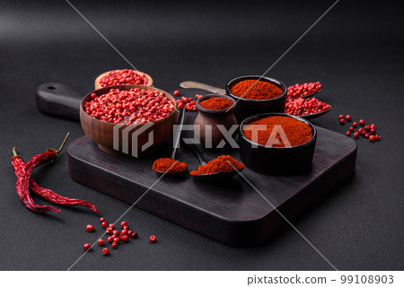 Spice smoked paprika in the form of powder in bowls and spoons Spice smoked paprika in the form of powder in bowls and spoons 99108903