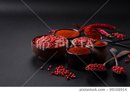 Spice smoked paprika in the form of powder in bowls and spoons Spice smoked paprika in the form of powder in bowls and spoons 99108914