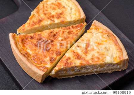 Beautiful delicious quiche pie with four types of cheese with spices and herbs 99108919