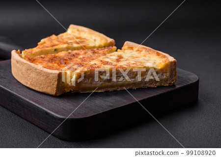 Beautiful delicious quiche pie with four types of cheese with spices and herbs 99108920